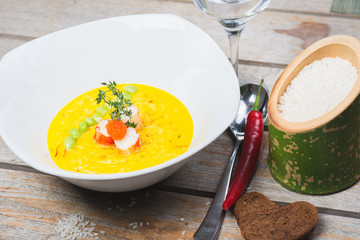 Traditional rice with seafood, risotto with rice and shrimp in a deep white plate on a table in a restaurant.