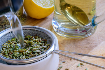 fennel seeds inside sieve being brewed for healthy drink