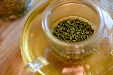 fennel seeds inside glass teapot being brewed for healthy drink