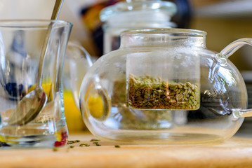 fennel seeds inside glass teapot being brewed for healthy drink