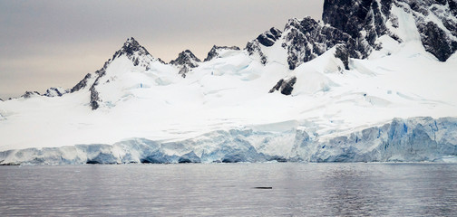 Snowy mountain landscapes at icebergs in the ocean at Antarctica-