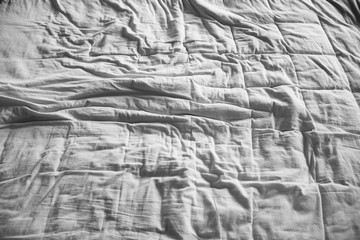 Messy unmade bed with duvet quilt