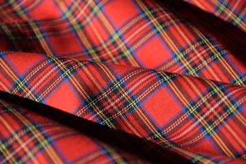 Red tartan fabric close up 