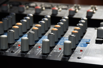 Fototapeta premium Close up of the controls on an audio mixer desk