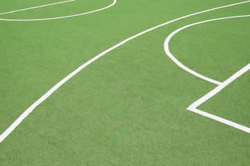 Fototapeta na wymiar A green sports turf surface with white painted lines