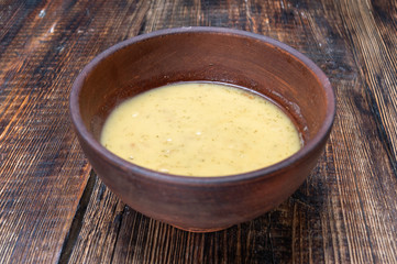 Bean soup in a clay bowl. Bowl on a wooden background.