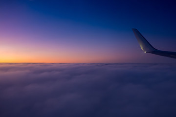 Sunset seen from the plane above the clouds