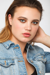 Candid young teenage girl studio Portrait looking at the camera. Natural face. Vertical photo