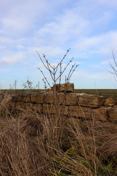 A country stone wall with a blue aky background 