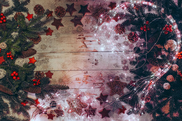Christmas background with fir twigs, red berries, cones and Xmas decoration.