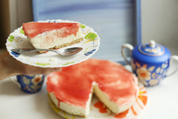 cheese cake with strawberry jam topping close up photo