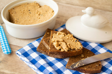 the pate of duck with bread on kitchen table.