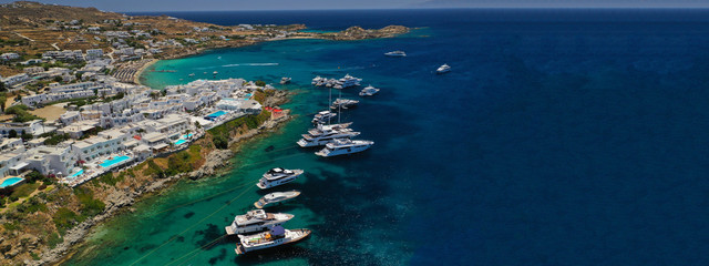 Aerial drone ultra wide photo of famous celebrity beach of Psarou in island of Mykonos, Cyclades,...