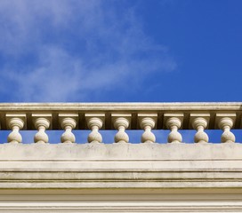 Fototapeta na wymiar White ornamental stone balustrade against blue sky