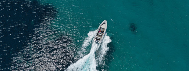 Aerial drone ultra wide photo of water sports in Super Paradise beach in island of Mykonos,...