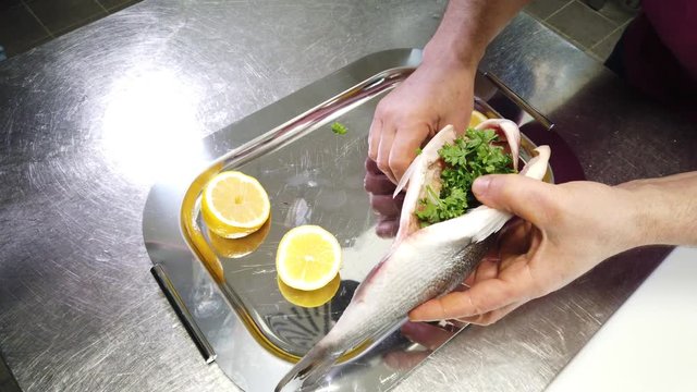 Chef stuffing fish dorade
