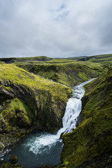 Fototapeta na wymiar Waterfall at river Skoga in Iceland Highlands on a cloudy day, hiking Fimmvördurhals