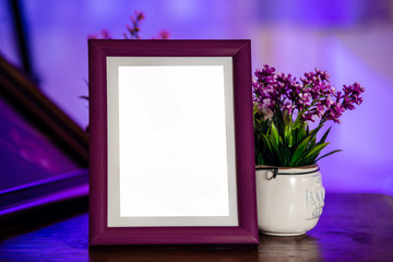 Beautiful purple empty photo frame on the table