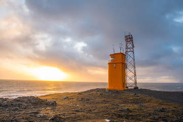 The lighthouse of Hvalnes in Iceland with the atlantic ocean in the background