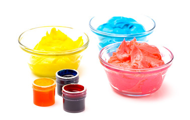 Opened Pots of Red Yellow and Blue Gel Food Coloring for Baking on a White Background