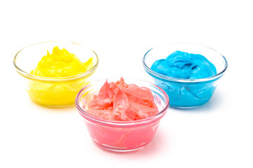 Bowls of Brightly Colored Icing Mixed withed with Gel Food Coloring