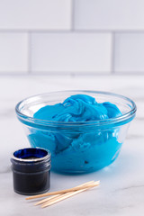 Pot of Gel Food Coloring on a Marble Counter Top