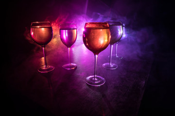 Goblet of white wine on wooden table on wooden wall background