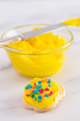 Cookies Decorated with Bright Yellow Colored Frosting with Fun Sprinkles