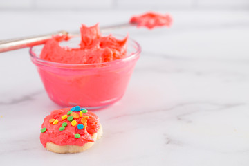 Cookies Decorated with Bright Pink Icing and Colorful Sprinkles
