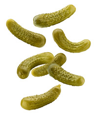 Falling marinated pickled cucumbers isolated on white background, clipping path, full depth of field