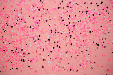 Pink background with small circles.