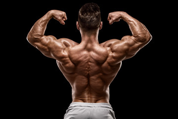 Muscular man showing back muscles rear view, isolated on black background. Strong male naked torso - obrazy, fototapety, plakaty