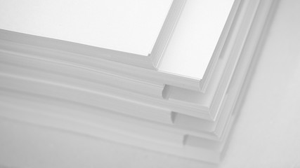 Obraz premium Several stacks of white paper on a white background