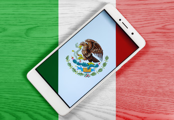 Creative Mexican Flag Consisting of a Smartphone over a Wooden Background
