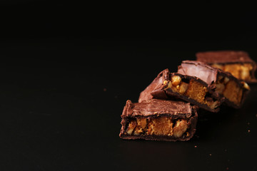 Italian chocolate with biscuit and nuts on a black background, Copy space