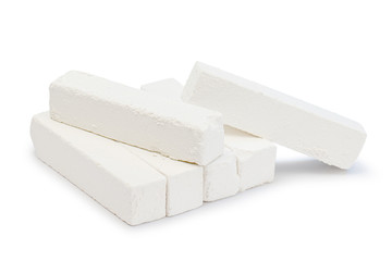 Piece of chalk isolated on white. Pure soft whitish calcite. White, sawn, natural mined chalk, environmentally friendly product. Tasty pica