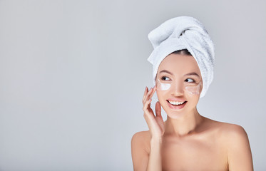 Image of a beautiful Asian woman with hydrogel patches under her eyes.