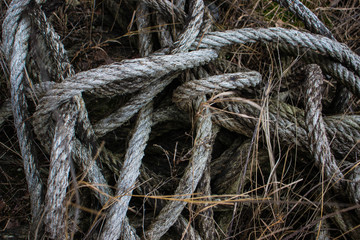 Old marine rope of gray color. Someone forgotten for a long time