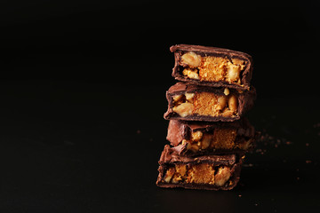Italian chocolate with biscuit and nuts on a black background, Copy space