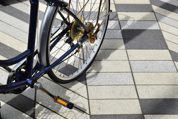Fototapeta na wymiar Bicycle rear wheel on a hard tiled surface