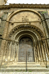 Fototapeta na wymiar Uncastillo, Aragon, Spain April 22, 2018 Church of Santa Maria la Mayor 10th century facade and front door