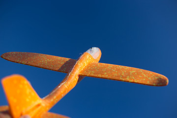 styrofoam yellow plane in the blue sky