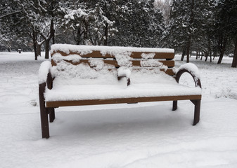 A bench covered by snow in a park of Beijing
