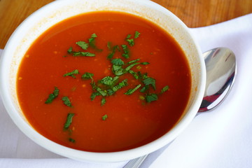 A bowl of tomato vegetable soup at an Indian restaurant