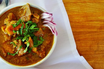 A dish of rogan josh red goat curry at an Indian restaurant - obrazy, fototapety, plakaty