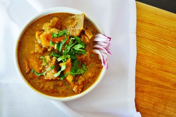 A dish of rogan josh red goat curry at an Indian restaurant - obrazy, fototapety, plakaty