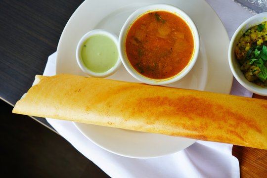 A Plate With Masala Dosa Bread Stuffed With Potatoes At An Indian Restaurant