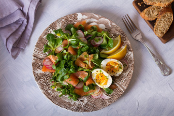Salmon egg radish and lamb leaves salad. Healthy diet food. View from above, top view