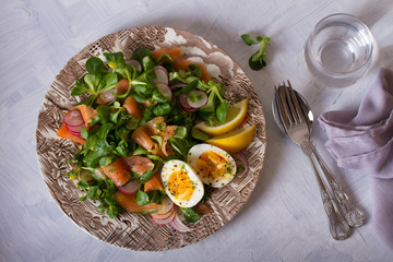 Salmon egg radish and lamb leaves salad. Healthy diet food. View from above, top view