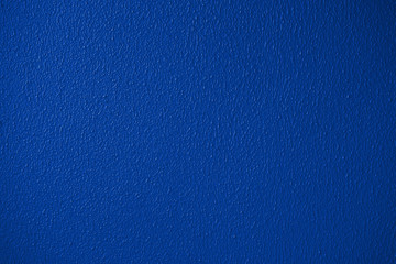 Blue or classic trendy color plaster wall texture detailed close-up
